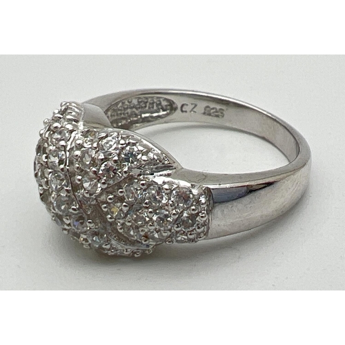 1027 - A silver and cubic zirconia multi-stone kiss ring set with 53 small round cut stones. Stamped 925 in... 