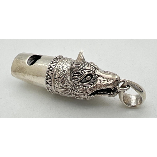 1122 - A 925 silver whistle modelled as a wolfs head, with hanging bale. Marked 925 to underside. Approx. 4... 