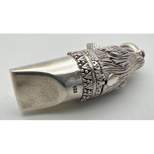 1122 - A 925 silver whistle modelled as a wolfs head, with hanging bale. Marked 925 to underside. Approx. 4... 