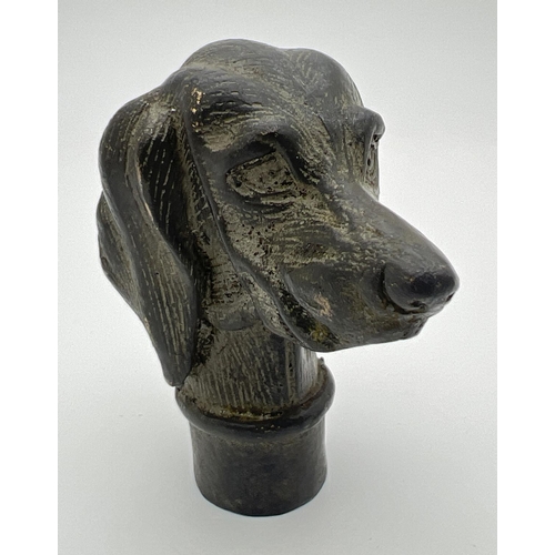 1143 - A vintage hollow bronze walking cane handle modelled as a dogs head. Approx. 7cm long.