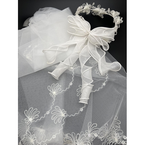 1331 - A boxed vintage Pronuptia floral bridal headdress with spiral bow detail to back. Together with a we... 