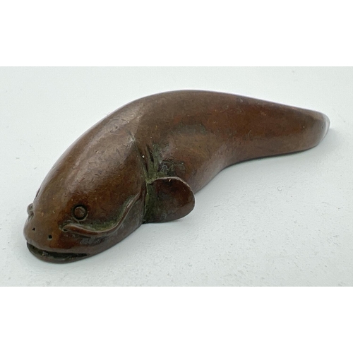 1275 - A signed miniature Japanese bronze, modelled as a catfish. Impressed signature to underside. Approx.... 