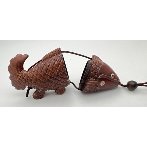 1211 - A carved wooden Oriental inro modelled as a catfish with carved mouse shaped pendant. With bone set ... 