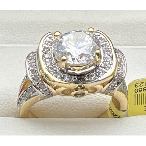 1028 - A 14kt gold plated Swarovski crystal set cocktail ring, new with tags. Decorative high shoulder and ... 