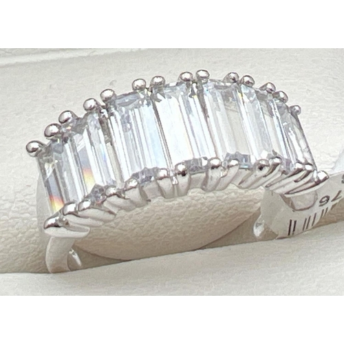 1029 - A Rhodium plated cocktail ring set with Swarovski crystals. Band style ring set with 7 baguette cut ... 