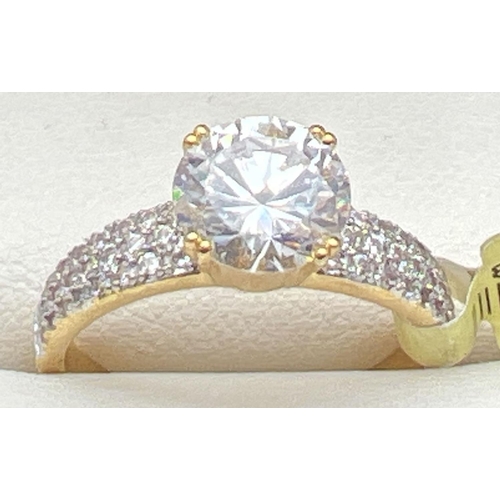 1034 - A new with tags 14kt gold plated cocktail ring set with Swarovski crystals. Central round cut clear ... 