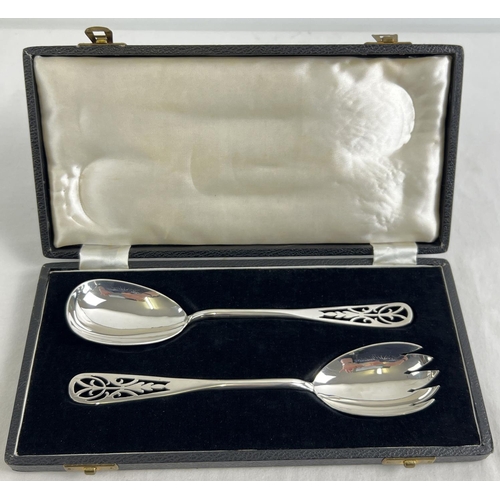 A late 1940's silver pair of salad servers with decorative pierced detail to handles, in original velvet lined case. Both fully hallmarked to reverse of bowl for Sheffield 1948 and with D.N.H & S makers mark. Total silver weight approx. 154.5g.
