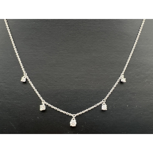 1043 - A Luke Stockley, London, 18ct white gold and diamond waterfall style necklace. 18 inch fine belcher ... 