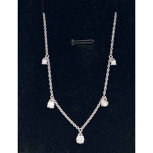 1043 - A Luke Stockley, London, 18ct white gold and diamond waterfall style necklace. 18 inch fine belcher ... 