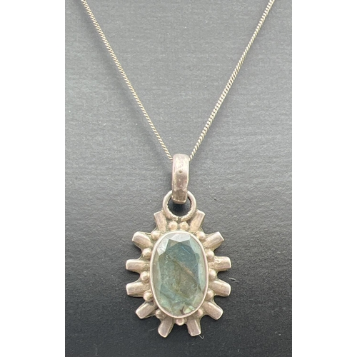 1045 - A sun-ray design oval shaped pendant set with labradorite, on a 16