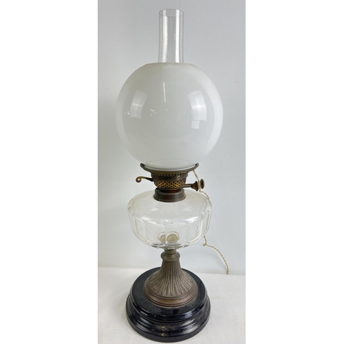 1279 - A vintage oil lamp with faceted clear glass bowl, white glass shade, chimney and stepped ceramic bas... 