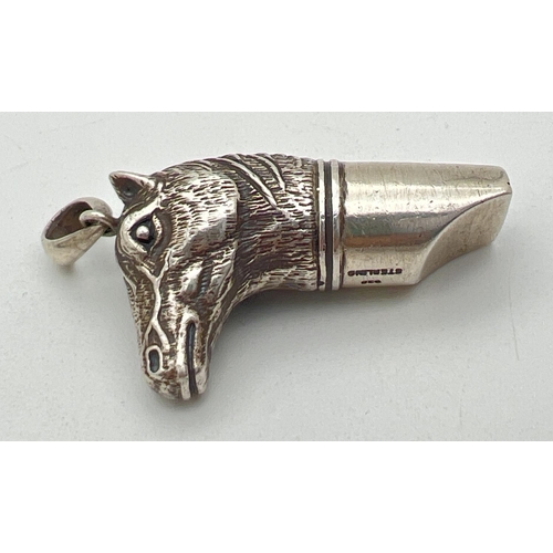 1129 - A silver whistle in the shape of a horses head, with pendant bale. Marked 925 Sterling. Approx. 5cm ... 