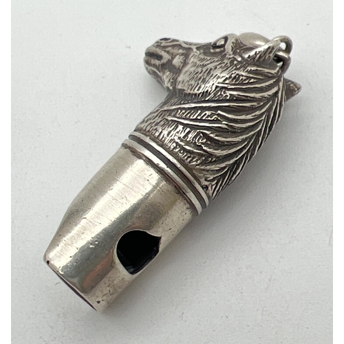 1129 - A silver whistle in the shape of a horses head, with pendant bale. Marked 925 Sterling. Approx. 5cm ... 