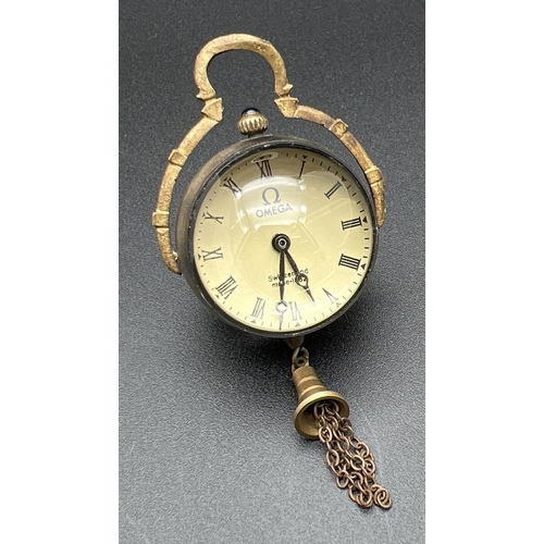 1110 - A brass bound ball watch pendant with tassel detail, roman numeral markers & hinged pendant bale. To... 