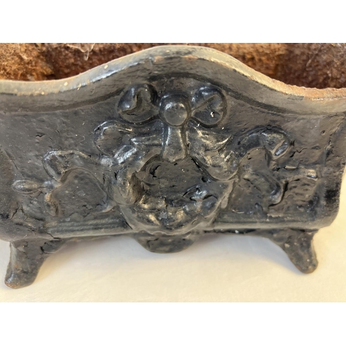 1148 - A pair of antique cast iron footed planters, painted black with floral & swag detail. Each approx. 1... 