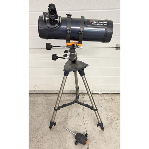 1238 - A Celstron Astromaster 114 astronomy telescope with tripod base and fixings. Extending feet to base.... 