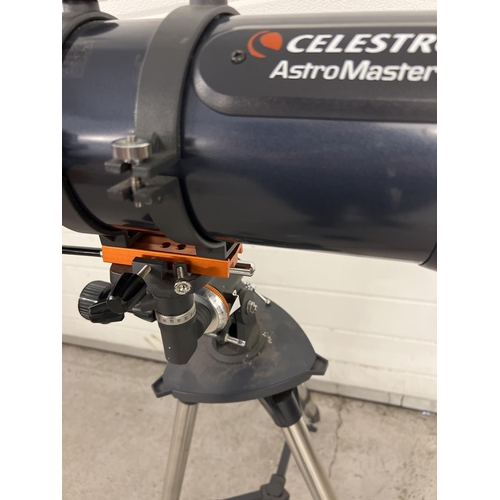 1238 - A Celstron Astromaster 114 astronomy telescope with tripod base and fixings. Extending feet to base.... 