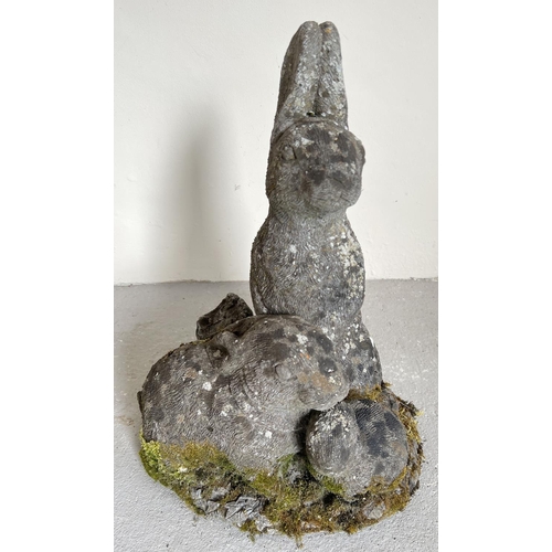 1474 - A large weathered concrete garden ornament of rabbits. Approx. 46cm tall.