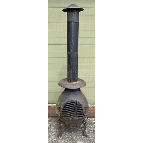 1480 - A large garden chiminea raised on tripod feet of scroll design. With repair made near door hinge. Ap... 