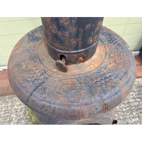 1480 - A large garden chiminea raised on tripod feet of scroll design. With repair made near door hinge. Ap... 