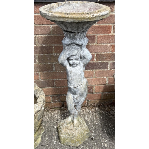 1482 - A tall concrete garden bird bath with pedestal base modelled as a young child of classical design. A... 