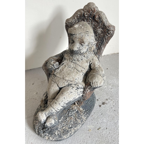 1490 - A large concrete garden ornament of a gnome asleep in an armchair. Approx. 43cm tall x 48cm long.