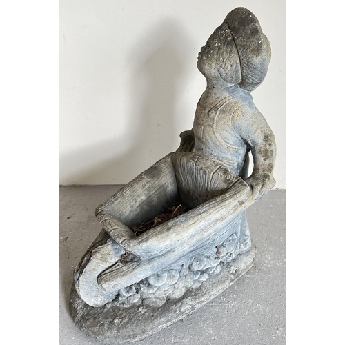 1492 - A large concrete garden planter modelled as a boy pushing a wheel barrow. Approx. 55cm tall x 40cm l... 