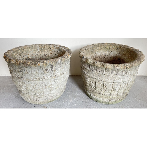 1502 - A large pair of circular shaped concrete garden planters with shaped rims and pannelled design. Appr... 