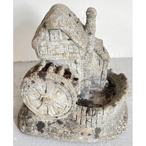 1504 - A large concrete garden ornament modelled as a watermill. Approx. 35cm tall x 38cm long.