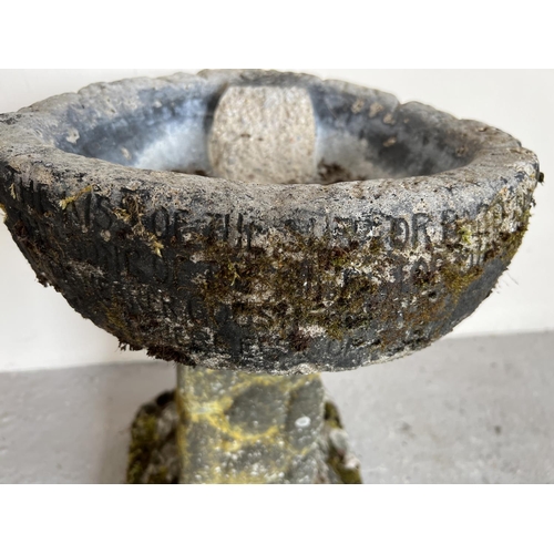 1511 - A vintage weathered concrete bird bath with pebbled effect base and bath with written verse. Bath is... 