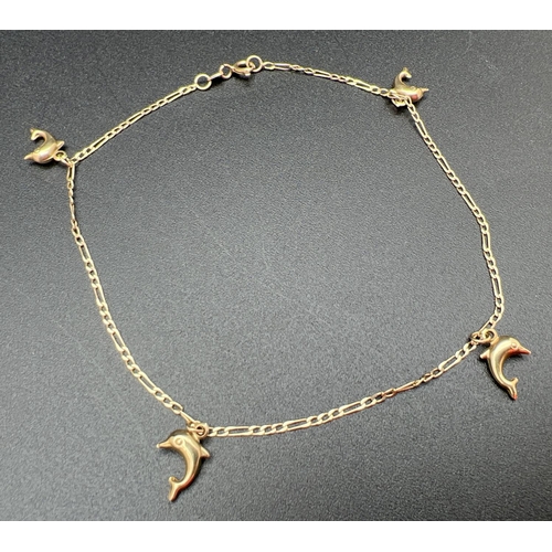 1058 - A 9ct gold figaro curb chain bracelet/anklet with 4 suspended dolphin pendants. 10