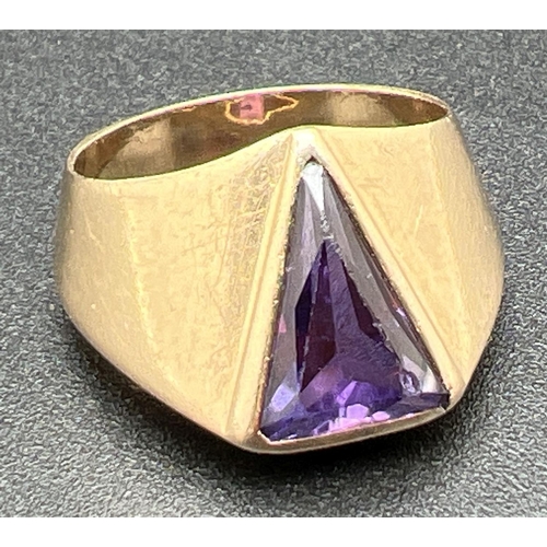 A modern design 10k gold chunky ring set with triangular shaped purple sapphire stone. Stamped '10k V&A' inside band. Ring size R. Total weight approx. 8g.