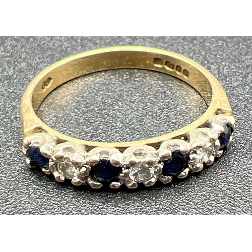 1065 - An 18ct gold half eternity ring set with 4 round cut sapphires and 3 round cut diamonds. Fully hallm... 