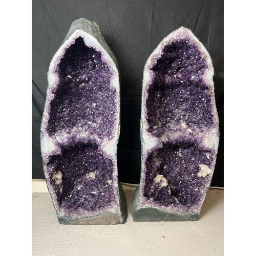 A very large amethyst crystal geode pair - rare as complete geode cut in half. Approx. 102cm tall and weigh approx. 73.6kg & 55.2kg.