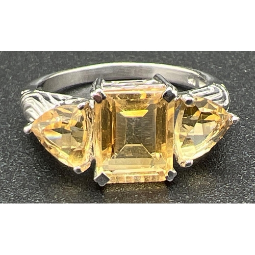 1069 - A silver and citrine 3 stone cocktail ring, set with square cut central stone flanked by 2 trilliant... 