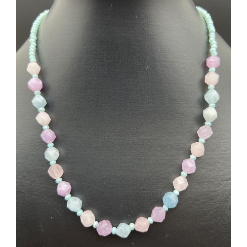 1074 - An aquamarine, rose quartz and amethyst 18