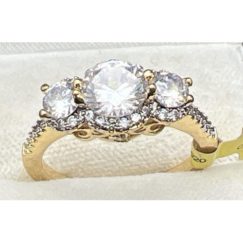 1077 - A 14ct gold plated cocktail trilogy ring set with Swarovski crystals, new with tags. 3 round cut sto... 