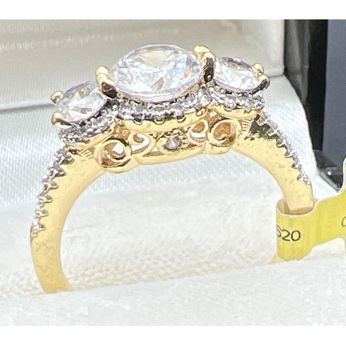 1077 - A 14ct gold plated cocktail trilogy ring set with Swarovski crystals, new with tags. 3 round cut sto... 