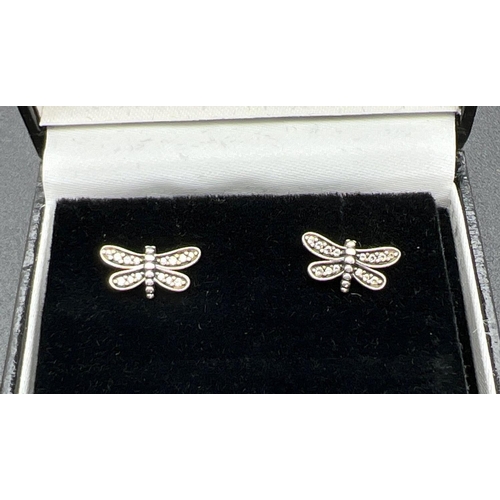 1079 - A pair of silver and clear stone set dragonfly stud earrings by Pandora. Edge of earrings marked S92... 