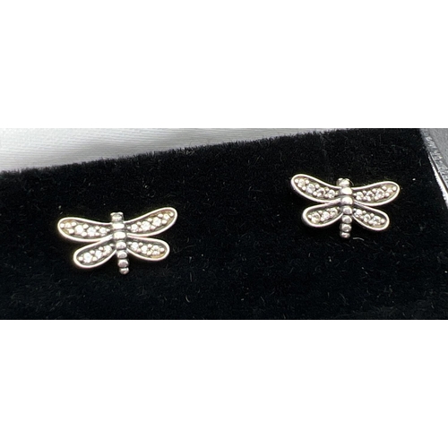 1079 - A pair of silver and clear stone set dragonfly stud earrings by Pandora. Edge of earrings marked S92... 