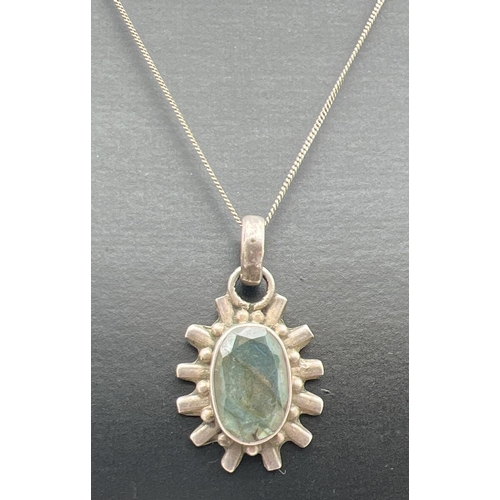 1086 - A silver sun-ray design oval shaped pendant set with labradorite, on a 16