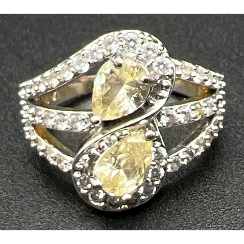 1092 - A 14ct gold plated cocktail ring set with Swarovski crystals. 2 teardrop cut pale lemon crystals set... 