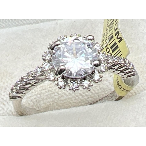 1094 - A rhodium plated cocktail ring set with Swarovski crystals (new with tags). Central round stone surr... 