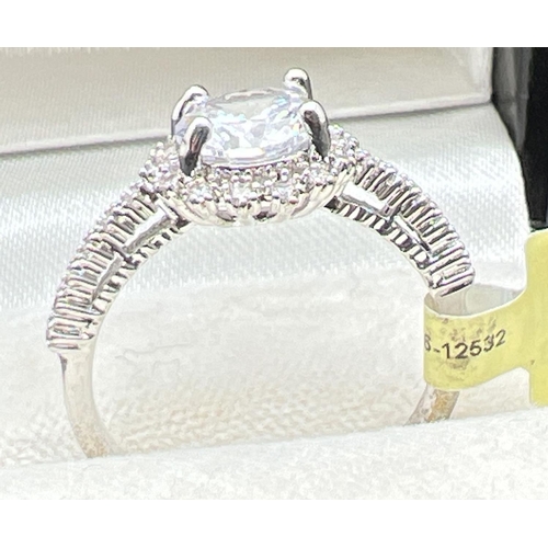 1094 - A rhodium plated cocktail ring set with Swarovski crystals (new with tags). Central round stone surr... 