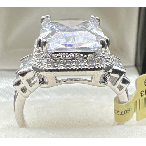 1095 - A rhodium plated cocktail ring set with clear Swarovski crystals, new with tags. A large square cut ... 