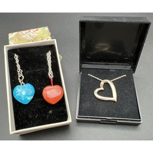 1098 - 3 heart shaped pendant necklaces with silver chains. A large open heart white metal pendant on an 18... 