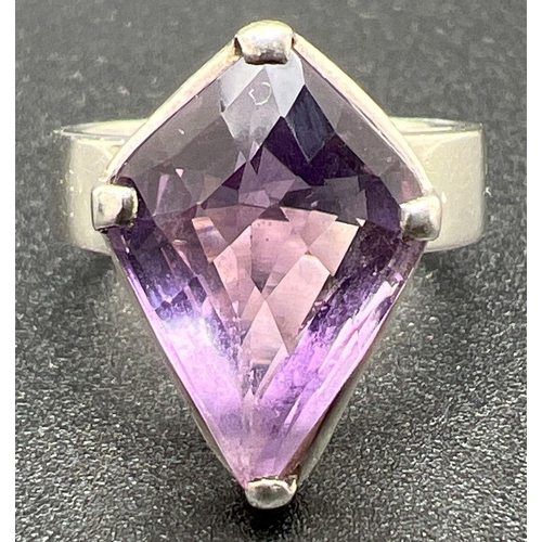 1102 - A 925 silver modern design wide band dress ring set with a large Kite cut amethyst. Stone approx. 2c... 