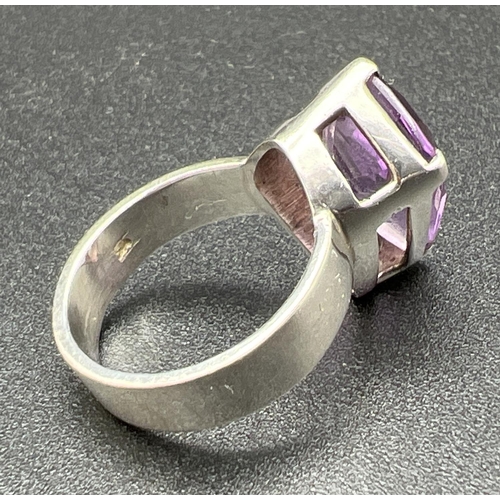 1102 - A 925 silver modern design wide band dress ring set with a large Kite cut amethyst. Stone approx. 2c... 