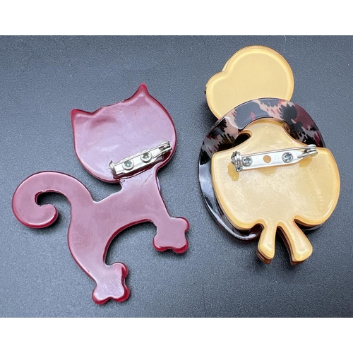 1103 - 2 lea Stein style Lucite brooches. A maroon coloured cat set with iridescent stones together with a ... 