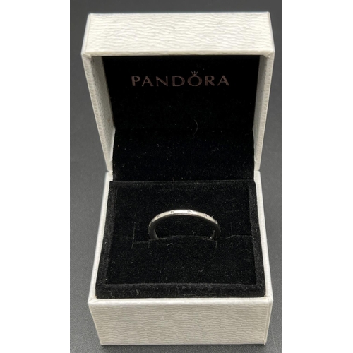 1107 - A boxed silver 'Simply Sparkling' band ring by Pandora. Marked inside of band S925 Ale 56. Size N½ o... 